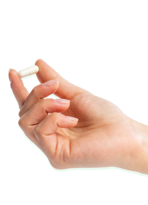 A hand holding a single Ancient Bliss capsule